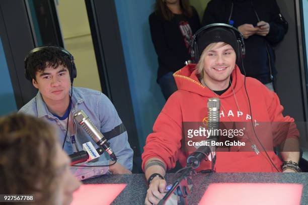 Bassist Calum Hood and guitarist Michael Clifford of 5 Seconds of Summer visit "The Elvis Duran Z100 Morning Show" at Z100 Studio on March 5, 2018 in...