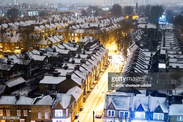 elevated view over london residential district in winter snow - rooftop at night stock pictures, royalty-free photos & images