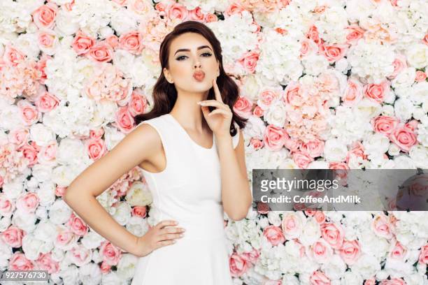 beautiful woman with curly hair - white rose garden stock pictures, royalty-free photos & images