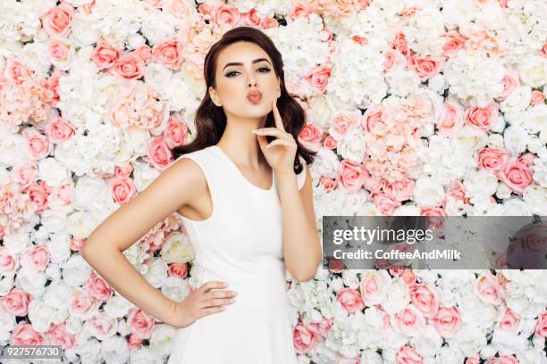 beautiful woman with curly hair - beautiful woman roses stock pictures, royalty-free photos & images