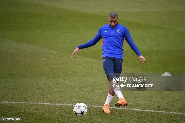 Paris Saint-Germain's French forward Kylian Mbappe kicks the ball during a training session on March 5, 2018 at the Ooredoo training center in...