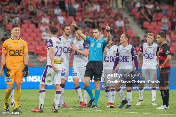 Referee Jarred Gillett signals for the video referee after Liam Reddy's tackle on Wanderers Jaushau Sotiro during the round 23 A-League match between...