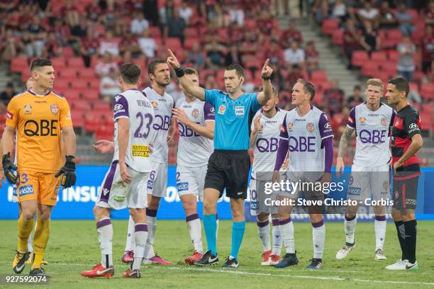 Referee Jarred Gillett signals for the video referee after Liam Reddy's tackle on Wanderers Jaushau Sotiro during the round 23 A-League match between...