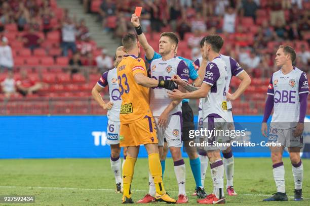 Referee Jarred Gillett issues Liam Reddy of Perth Glory a red card after his tackle on Wanderers Jaushau Sotirio during the round 23 A-League match...