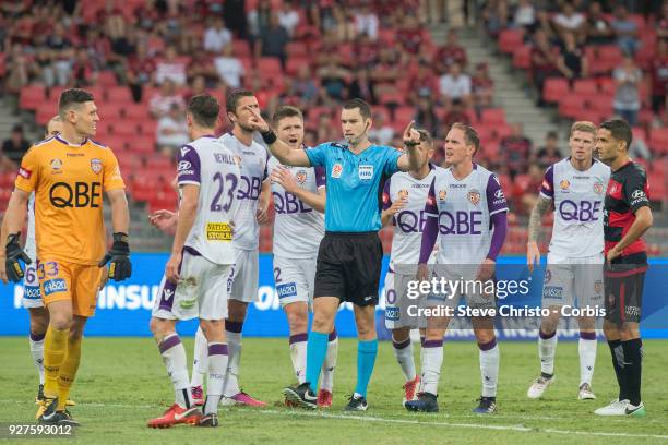 Referee Jarred Gillett signals for the video referee after Liam Reddy's tackle on Wanderers Jaushau Sotiro during the round 23 A-League match between...