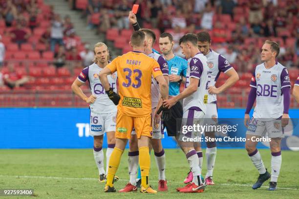 Referee Jarred Gillett issues Liam Reddy of Perth Glory a red card after his tackle on Wanderers Jaushau Sotirio during the round 23 A-League match...