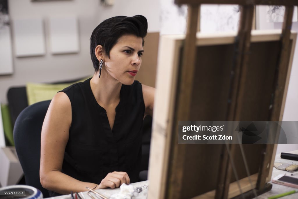 Artist painting in her studio