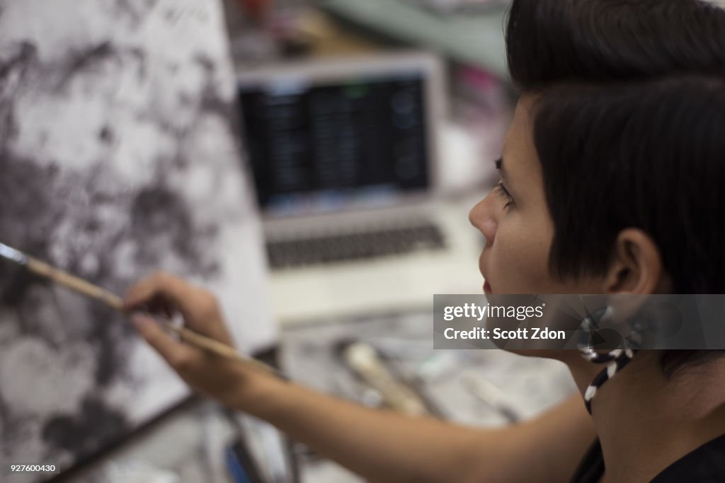 Artist painting in her studio