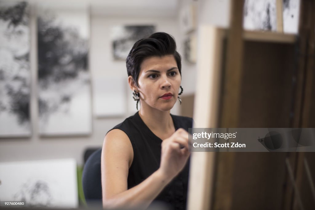 Hispanic artist working in her studio