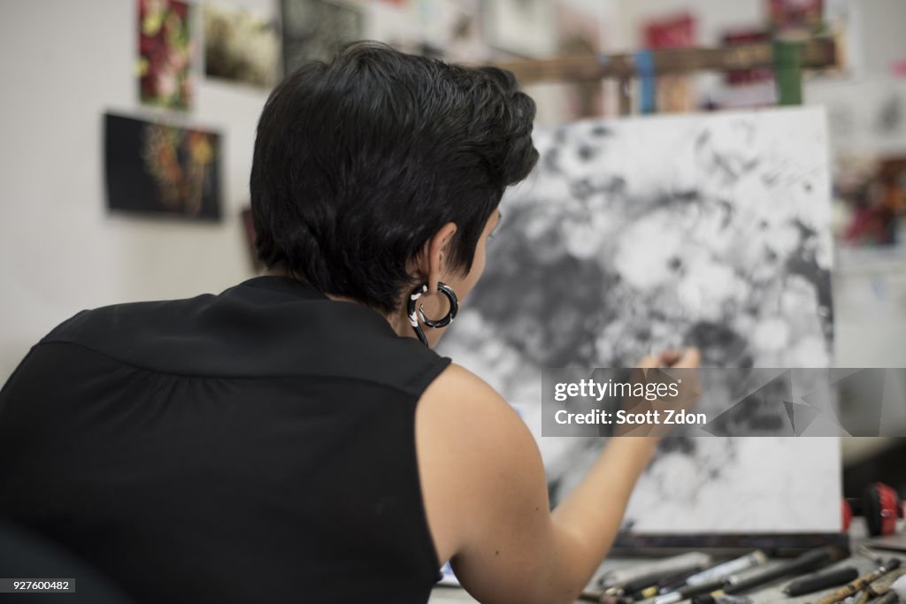 Hispanic artist working in her studio