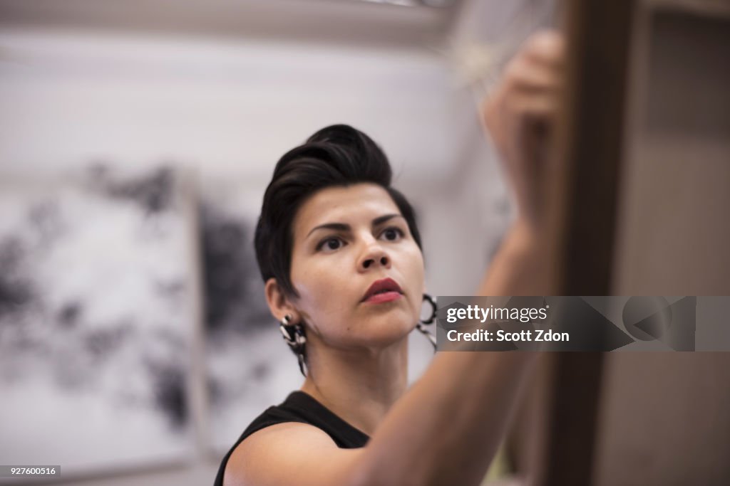 Artist painting in her studio