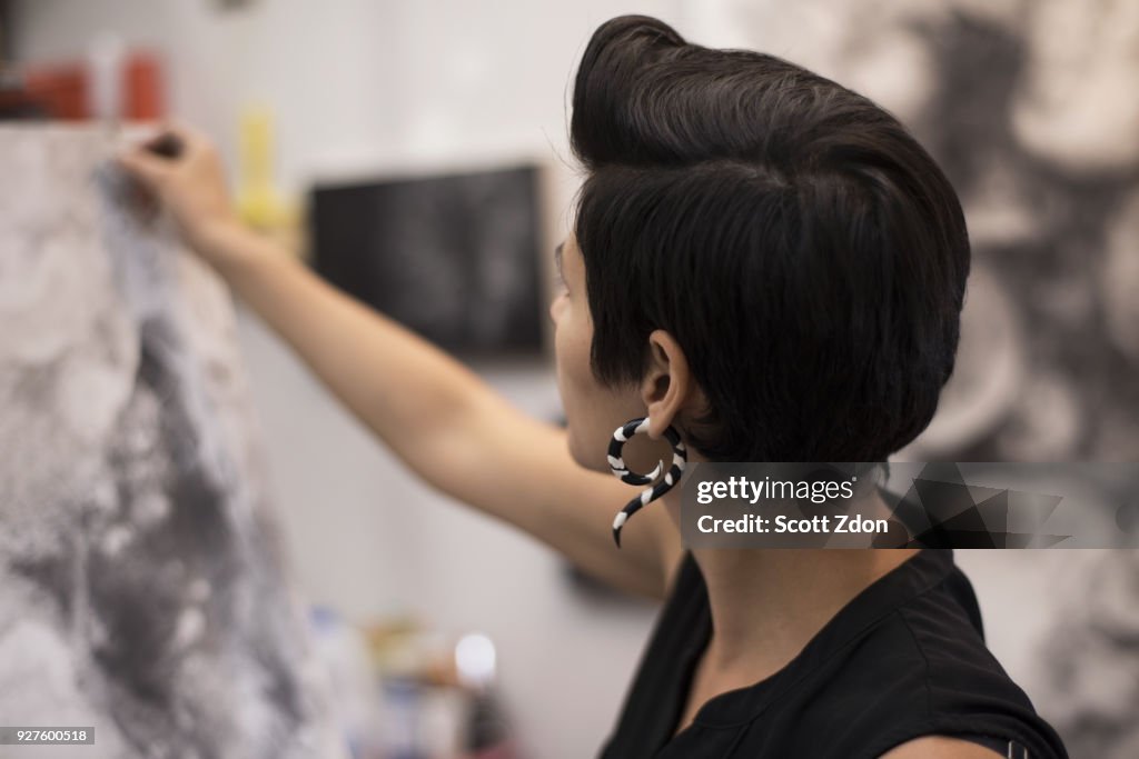 Artist painting in her studio