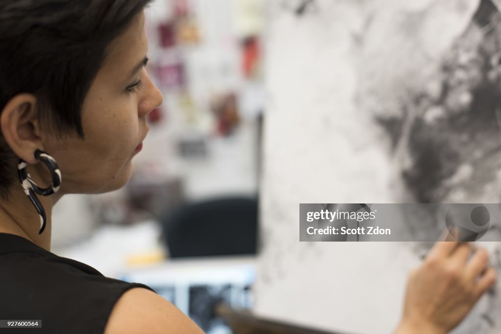 Artist painting in her studio