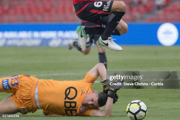 Glory's Liam Reddy slides under Marcelo Carrusca of the Wanderers during the round 23 A-League match between the Western Sydney Wanderers and Perth...