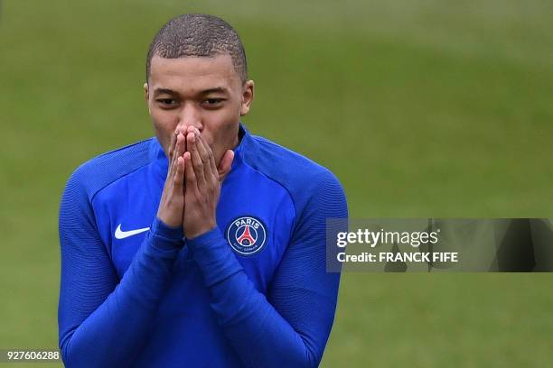 Paris Saint-Germain's French forward Kylian Mbappe reacts during a training session on March 5, 2018 at the Ooredoo training center in...