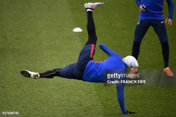 Paris Saint-Germain's Argentinian forward Angel Di Maria stretches during a training session on March 5, 2018 at the Ooredoo training center in...