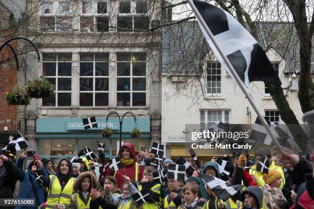 Cornish flags are waved by school children attending the St Piran's Day march, which celebrates St Piran, patron saint of tinners and regarded by...