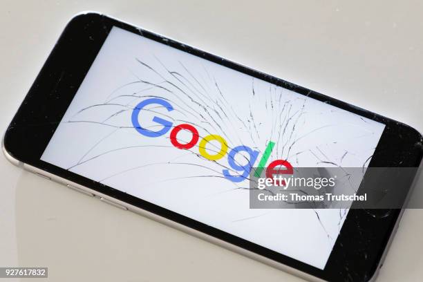 Berlin, Germany The logo of google is displayed on a smartphone with splintered glass on March 05, 2018 in Berlin, Germany.