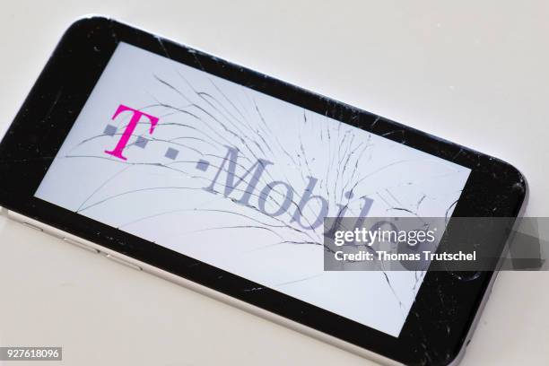 Berlin, Germany The logo of Telekom T-mobile is displayed on a smartphone with splintered glass on March 05, 2018 in Berlin, Germany.