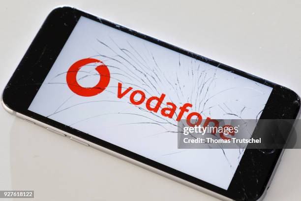 Berlin, Germany The logo of vodafone is displayed on a smartphone with splintered glass on March 05, 2018 in Berlin, Germany.