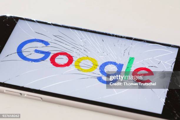 Berlin, Germany The logo of google is displayed on a smartphone with splintered glass on March 05, 2018 in Berlin, Germany.