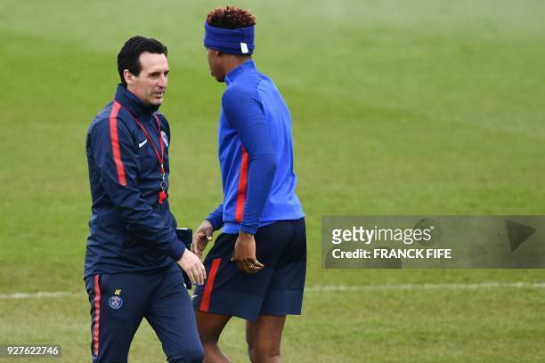 Paris Saint-Germain's Spanish headcoach Unai Emery and Paris Saint-Germain's French defender Presnel Kimpembe attend a training session on March 5,...