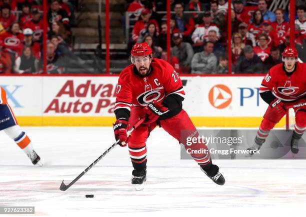 Justin Faulk of the Carolina Hurricanes skates hard on the ice during an NHL game against the New York Islanders on February 16, 2018 at PNC Arena in...