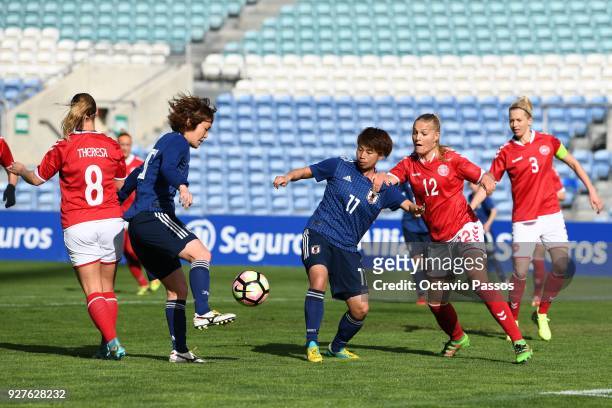 Theresa Nielsen of Denmark competes for the ball with Mizuho Sakaguchi of Japan during the Women's Algarve Cup Tournament match between Denmark and...