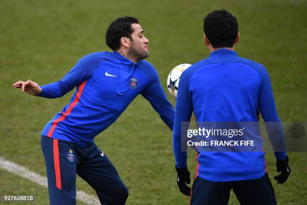 Paris Saint-Germain's Brazilian defender Daniel Alves and Paris Saint-Germain's Brazilian defender Marquinhos attend a training session on March 5,...