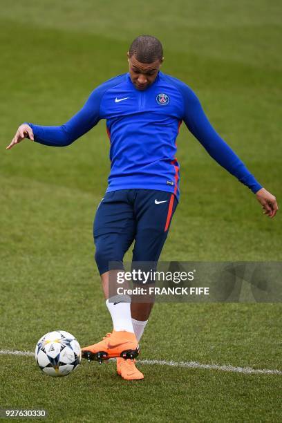 Paris Saint-Germain's French forward Kylian Mbappé kicks the ball during a training session on March 5, 2018 at the Ooredoo training center in...