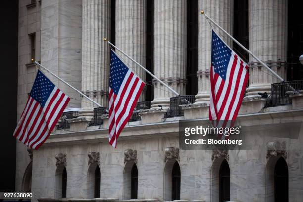 American flags hang on display outside the New York Stock Exchange in New York, U.S., on Monday, March 5, 2018. U.S. Stocks turned higher and...