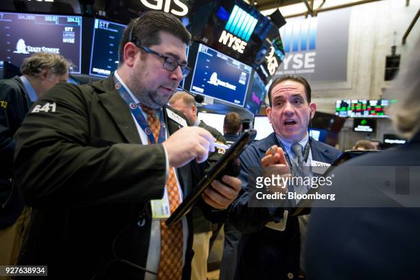 Traders work on the floor of the New York Stock Exchange in New York, U.S., on Monday, March 5, 2018. U.S. Stocks turned higher and Treasuries erased...