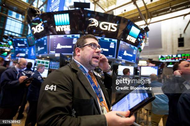 Trader works on the floor of the New York Stock Exchange in New York, U.S., on Monday, March 5, 2018. U.S. Stocks turned higher and Treasuries erased...