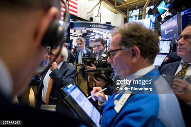 Traders work on the floor of the New York Stock Exchange in New York, U.S., on Monday, March 5, 2018. U.S. Stocks turned higher and Treasuries erased...