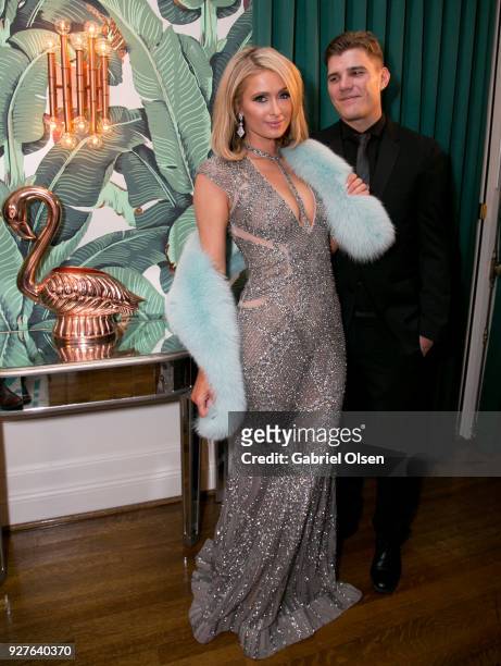 Paris Hilton and Chris Zylka attend the Treats! annual Oscars party at the private residence of Jonas Tahlin, CEO of Absolut Elyx on March 4, 2018 in...