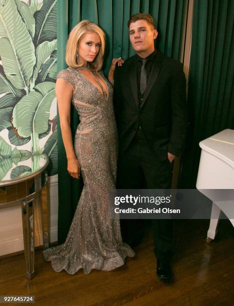 Paris Hilton and Chris Zylka attend the Treats! annual Oscars party at the private residence of Jonas Tahlin, CEO of Absolut Elyx on March 4, 2018 in...