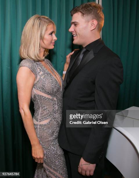 Paris Hilton and Chris Zylka attend the Treats! annual Oscars party at the private residence of Jonas Tahlin, CEO of Absolut Elyx on March 4, 2018 in...