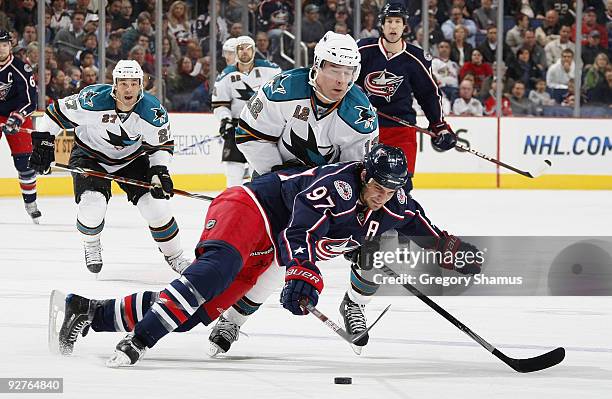 Rostislav Klesla of the Columbus Blue Jackets battles to gain control of the puck against Patrick Marleau of the San Jose Sharks on November 4, 2009...