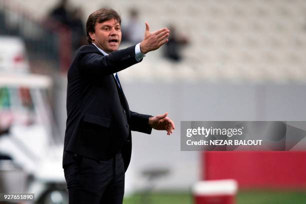 Tractor Sazi's Turkish coach Ertugrul Saglam speaks to his players during the AFC Champions League football match between al-Jazira and Tractor Sazi...
