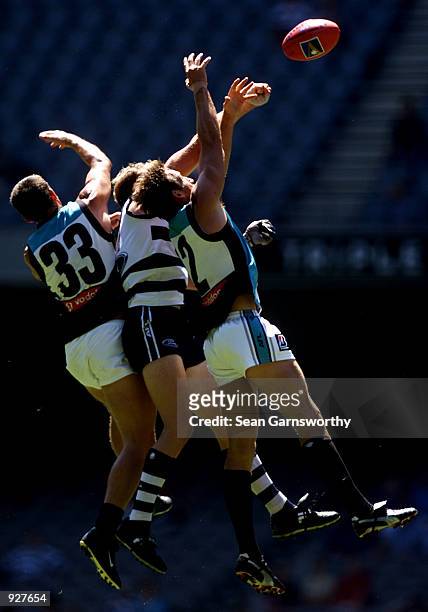 Darren Mead and Darryl Wakelin for Port Adelaide contest for the ball against David Mensch for Geelong during the Ansett Cup game between the Port...
