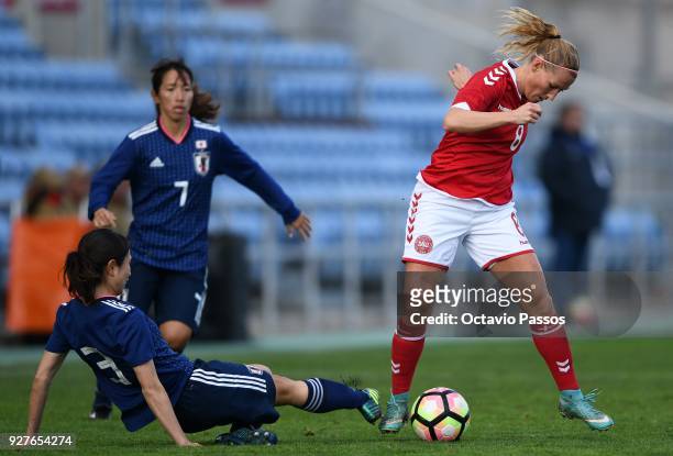 Theresa Nielsen of Denmark competes for the ball with Aya Sameshima of Japan during the Women's Algarve Cup Tournament match between Denmark and...