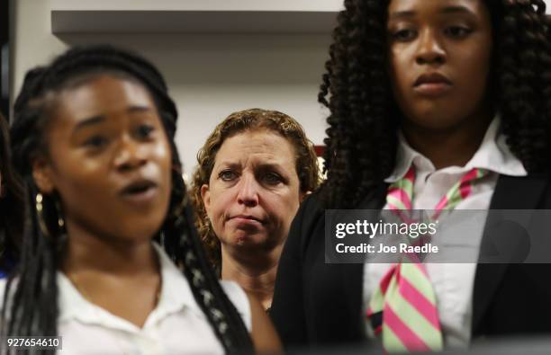 Rep. Debbie Wasserman Schultz looks on as Megan Hobson , who survived after being shot with an AK-47 when she was 16 years old, and Marjory Stoneman...