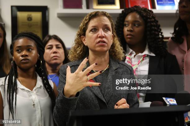 Rep. Debbie Wasserman Schultz speaks to the media as Megan Hobson , who survived after being shot with an AK-47 when she was 16 years old, and...