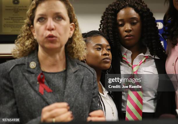 Rep. Debbie Wasserman Schultz speaks to the media as Megan Hobson , who survived after being shot with an AK-47 when she was 16 years old, and...