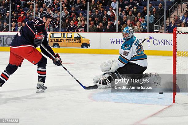 Jason Chimera of the Columbus Blue Jackets slips a shot past goaltender Evgeni Nabakov of the San Jose Sharks for the score during the first period...