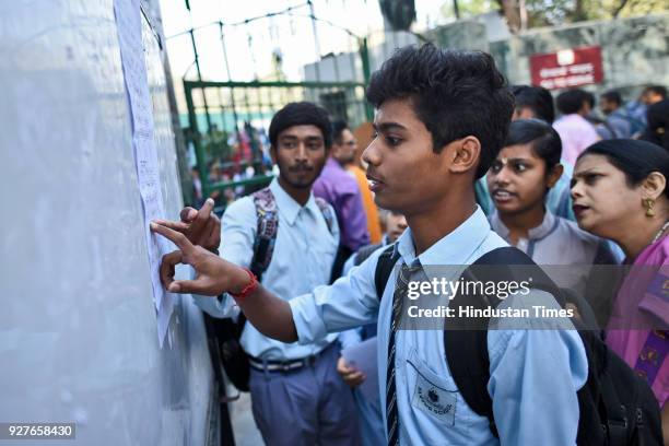 Students of Class X and XII check for their alloted rooms for the exams, at Kendra Vidyala Gole Market, on March 5, 2018 in New Delhi, India. The...