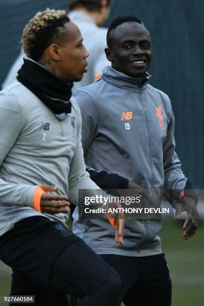 Liverpool's English defender Nathaniel Clyne and Liverpool's Senegalese midfielder Sadio Mane participate in a training session prior to the UEFA...