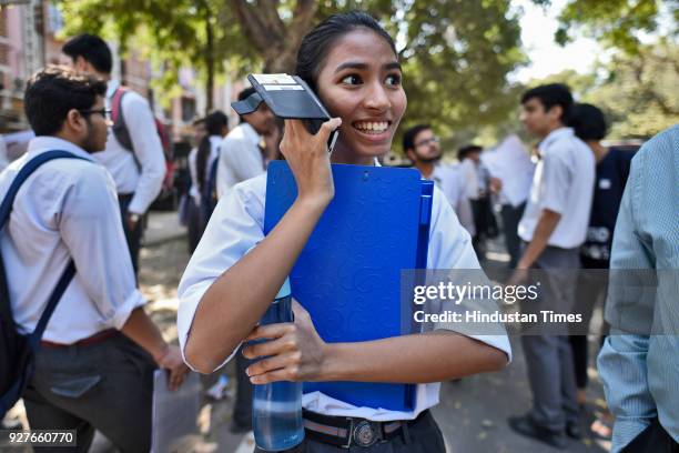 Girl talking on mobile phone after coming out from the Class XII CBSE exam at Bharatiya Vidya Bhavan, Copernicus Marg, on March 5, 2018 in New Delhi,...