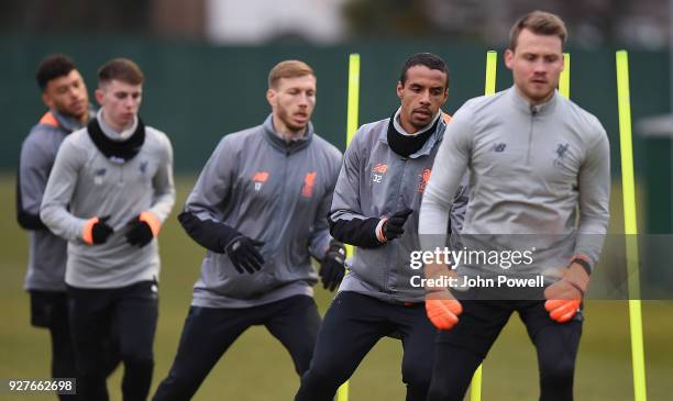 Joel Matip, Ragnar Klavan and Ben Woodburn of Liverpool during a training session at Melwood Training Ground on March 5, 2018 in Liverpool, England.