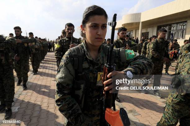 Members of the Kurdish People's Protection Units and Women's Protection Units attend the funeral of Kurdish fighters from the Syrian Democratic...